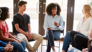 photo: students in conversation with teacher